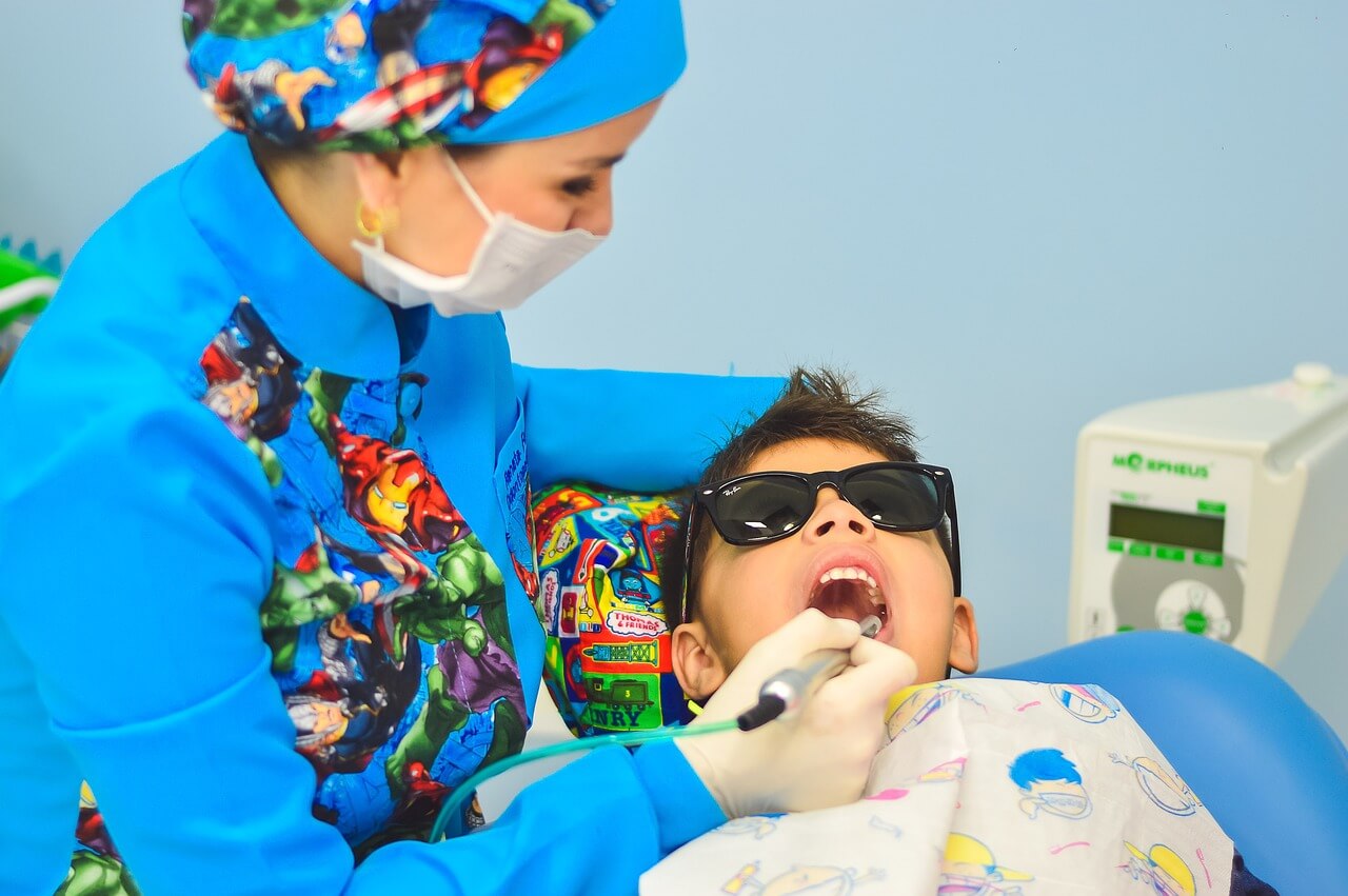 dentist with a child wearing sunglasses